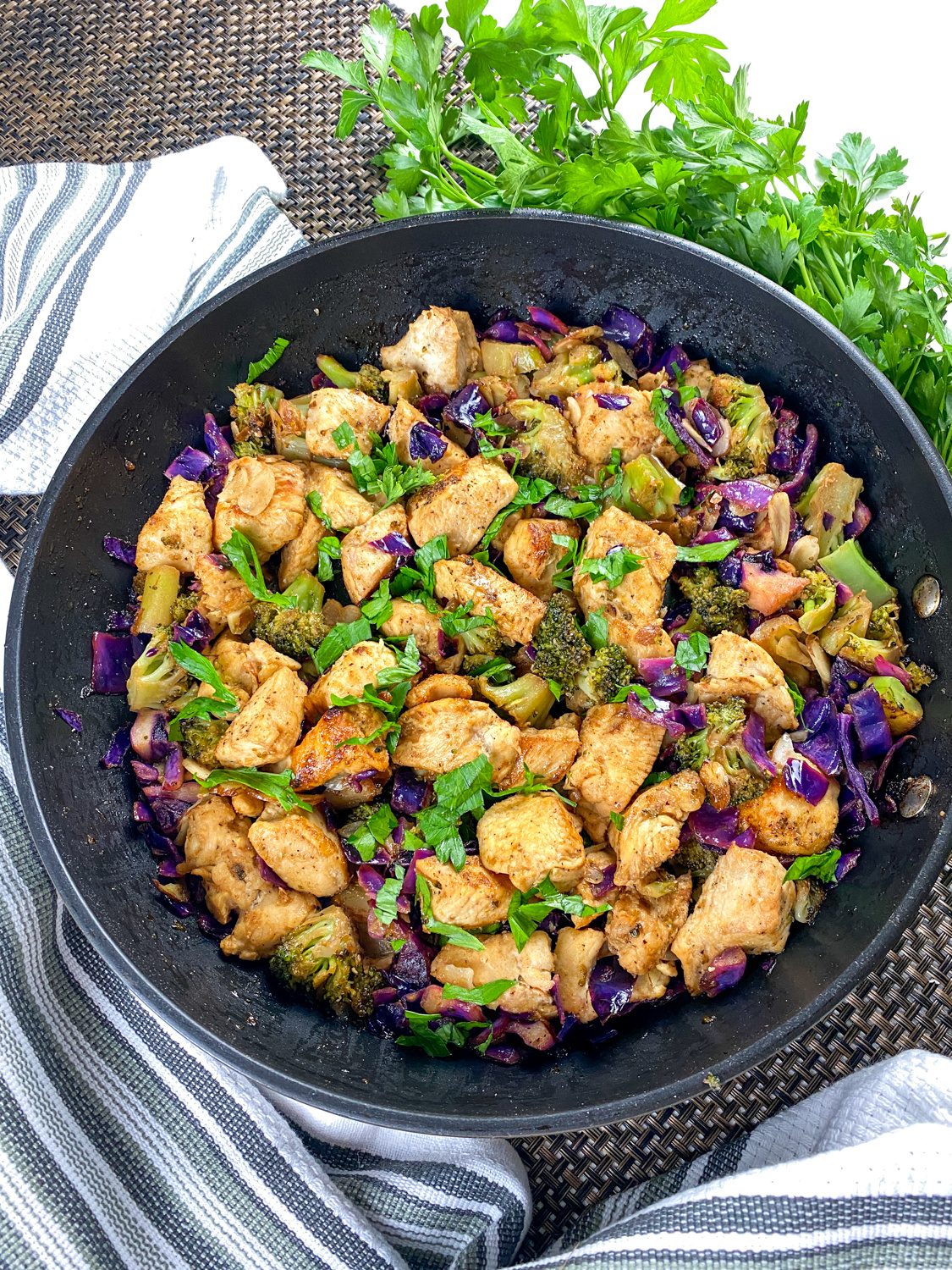Skillet of chicken, broccoli, and cabbage in a lemon garlic sauce