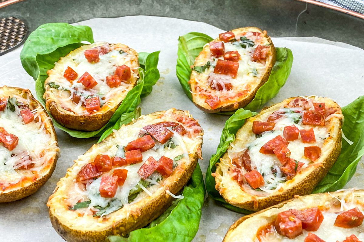 Pizza-stuffed potato skins topped with melted mozzarella, pepperoni, and fresh basil