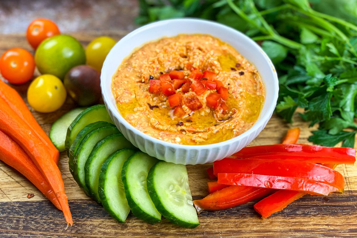 Bowl of spicy feta dip with roasted red peppers and red pepper flakes