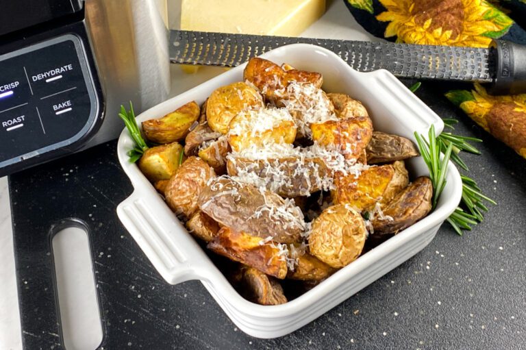 Crispy air fryer rosemary potatoes topped with shaved Parmesan