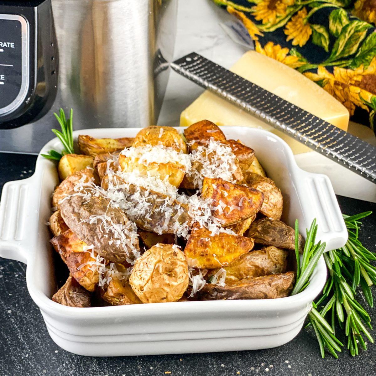 Crispy air fryer rosemary potatoes topped with shaved Parmesan