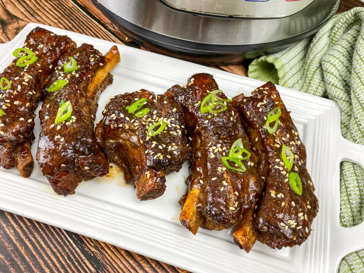 Glazed Asian sticky ribs with sesame seeds and green onions