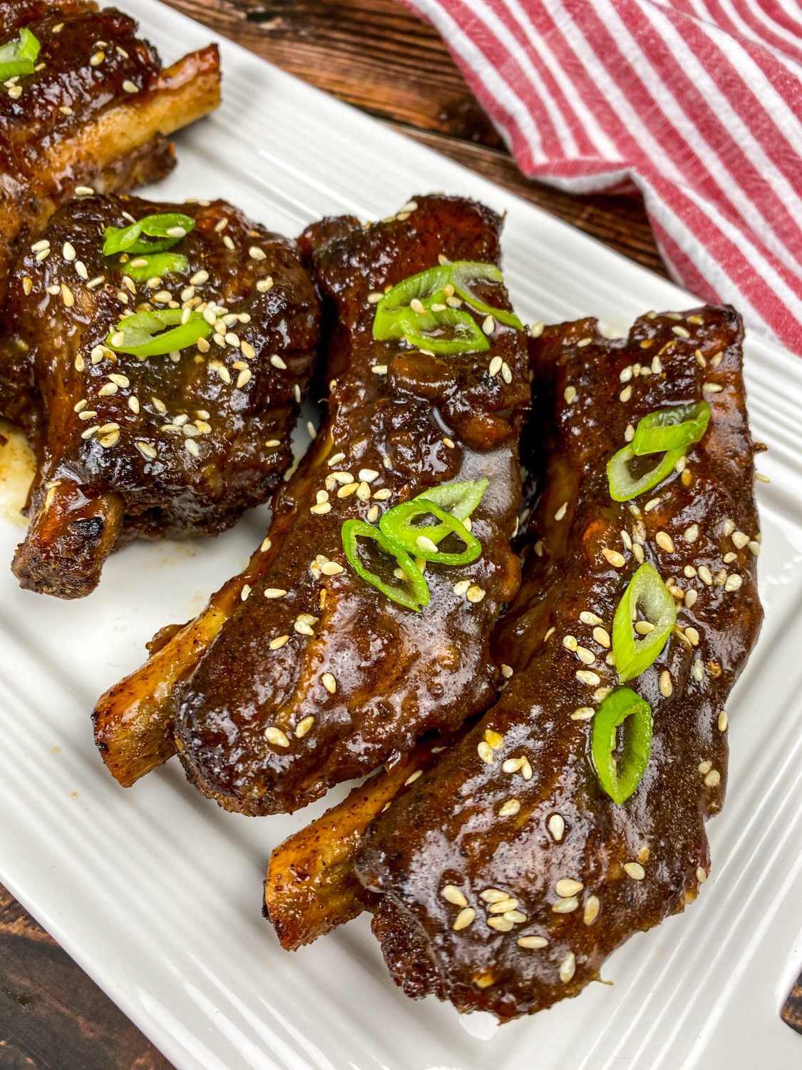 Glazed Asian sticky ribs with sesame seeds and green onions