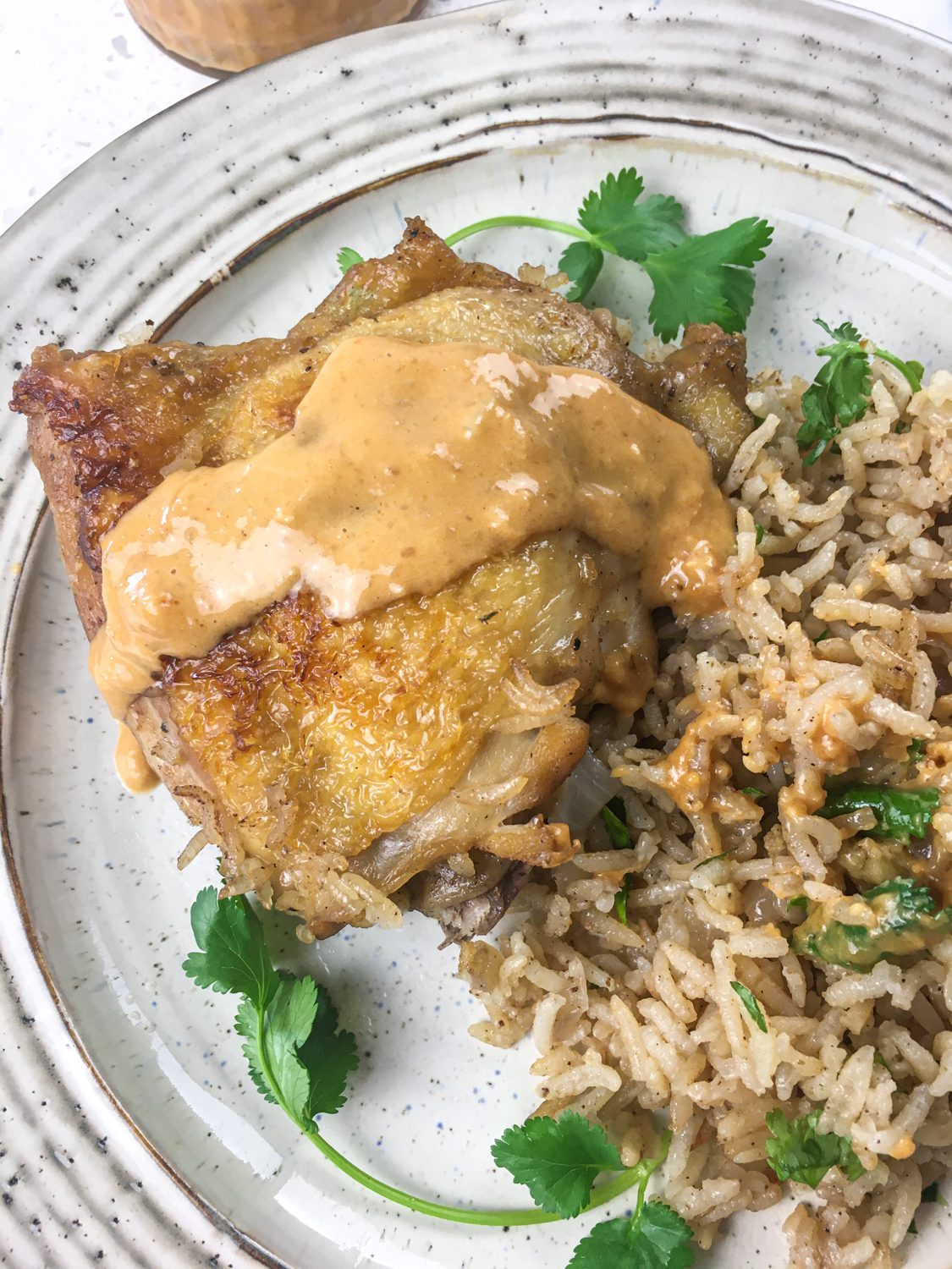 Dutch oven chicken over rice with a spicy peanut sauce