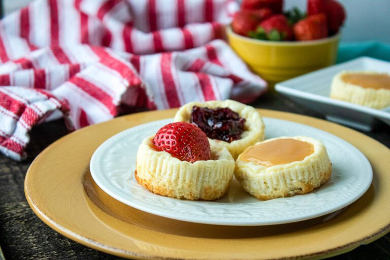 Mini crustless cheesecakes with raspberry jam, lemon curd, and fresh strawberries